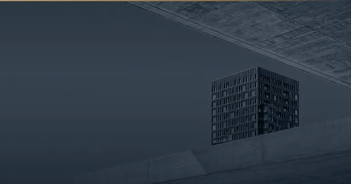 Auskragende Betonplatte vor einem dunklen Turm.